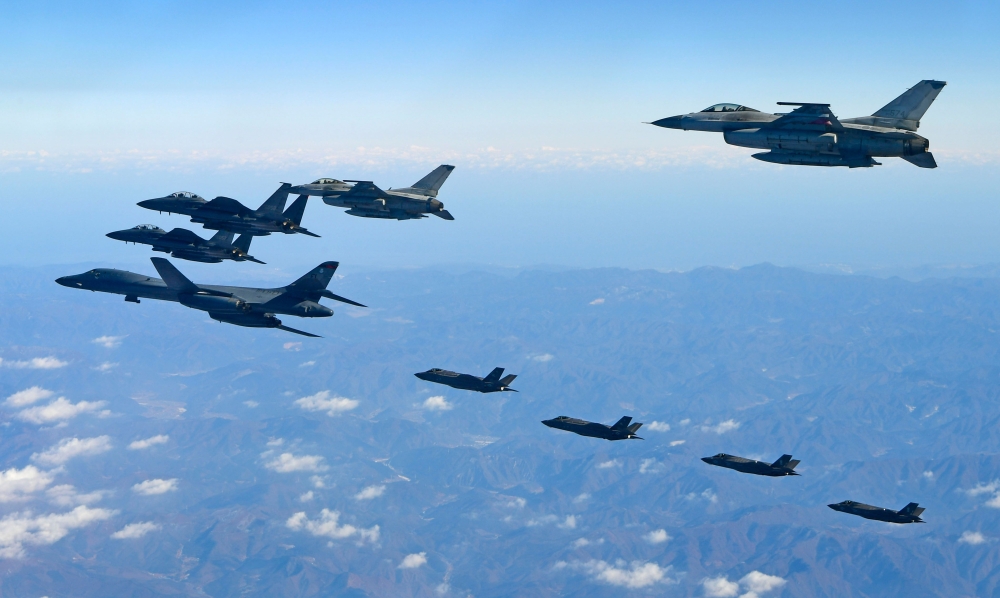 A US Air Force B-1B Lancer bomber, left, two US F-35A and two US F-35B stealth jets, far, fly over South Korea with South Korea’s two F-16, right, and two F-15K, left top, fighter jets during a joint military drill on Wednesday. — AFP

