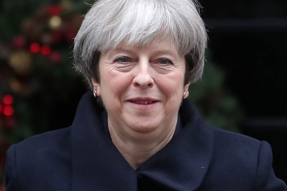 Britain’s Prime Minister Theresa May leaves 10 Downing Street in central London on Wednesday, ahead of the weekly Prime Minister's Questions (PMQs) session in the House of Commons. — AFP