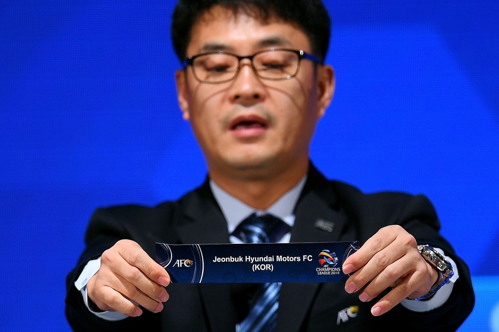 AFC National Team Competitions Director Shin Man Gil shows the draw for Jeonbuk Hyundai Motors FC of South Korea during the 2018 AFC Champions League football tournament official draw for group stages at the Asian Football Confederation headquarters in Kuala Lumpur on Wednesday. — AFP
