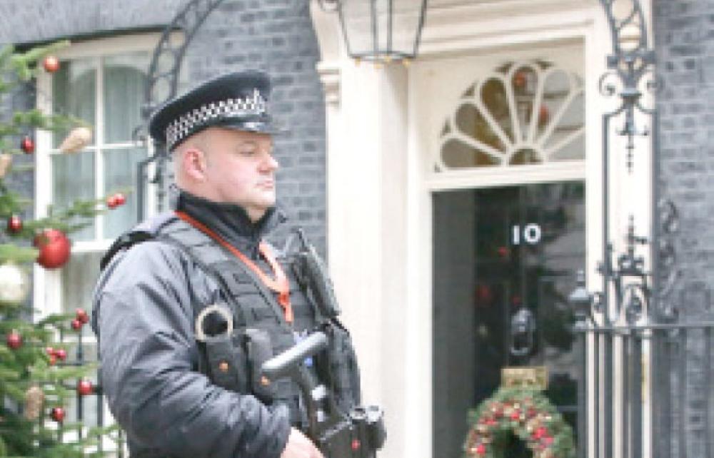 

An armed policeman carries his automatic weapon as he walks on patrol outside 10 Downing Street in central London on Wednesday. — AFP
