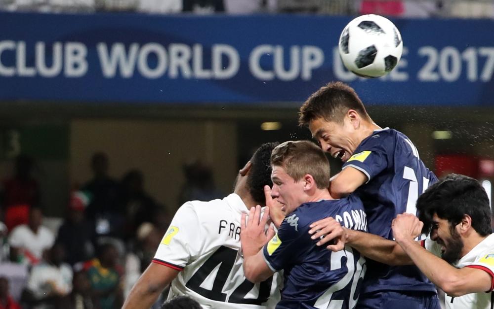 UAE's al-Jazira club players Mohamad al-Attas (R) and Fares Juma (L) and Auckland City's Kim Daewook (2R) and Callum McCowatt (2L) jump to head the ball during their FIFA Club World Cup UAE 2017 first round football match between al-Jazira and Auckland City FC at the Hazza Bin Zayed Stadium on December 6, 2017 in Al-Ain. — AFP