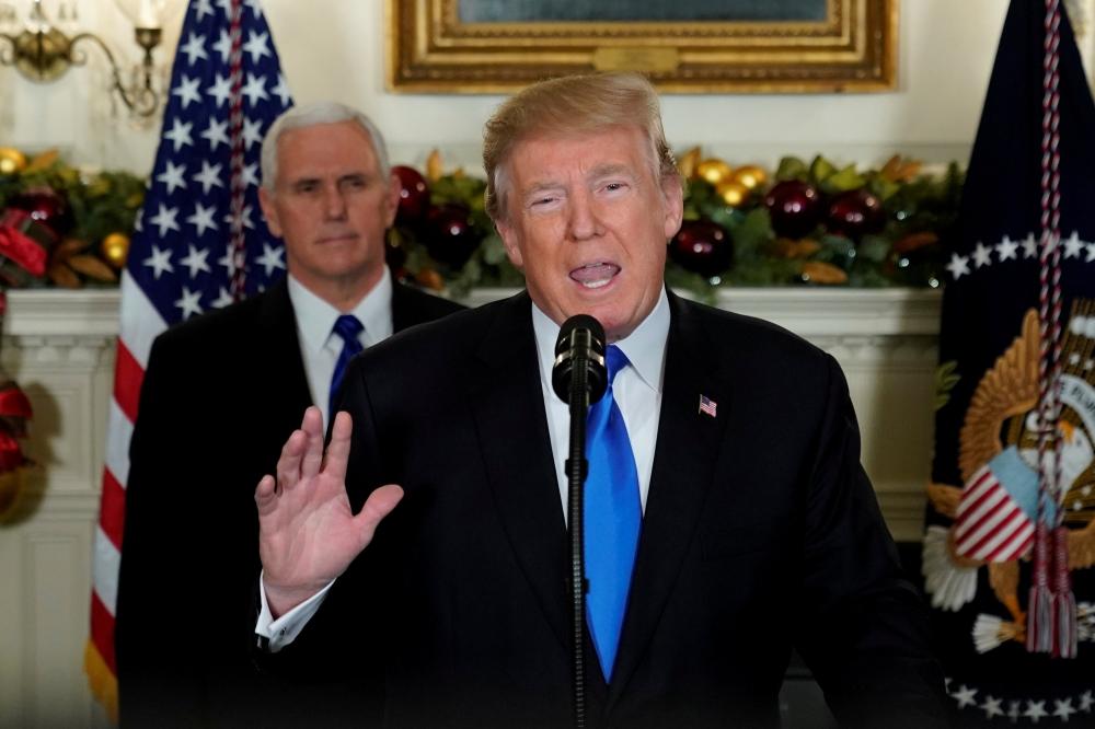  US President Donald Trump, flanked by ‪Vice President Mike Pence‬, delivers remarks recognizing Jerusalem as the capital of Israel at the White House in Washington, US on Wednesday.  — Reuters