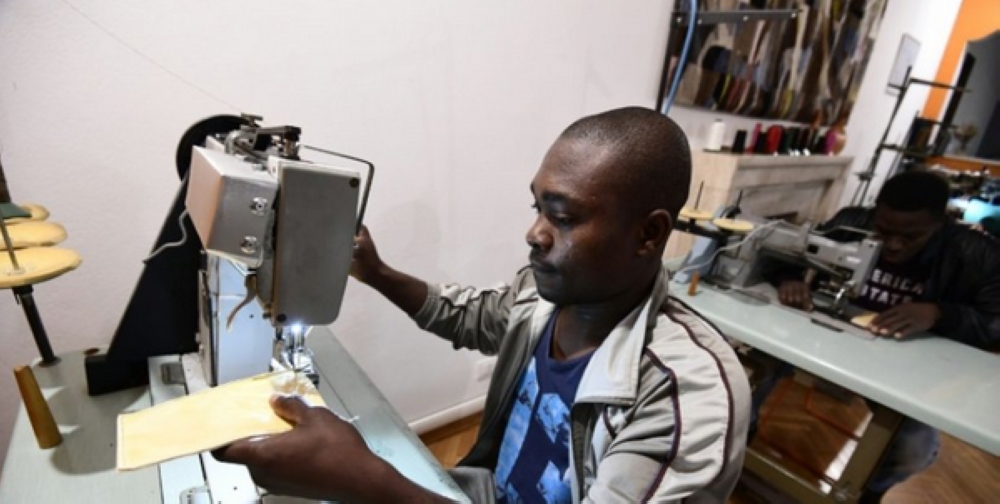 Handbags made by migrants at the Lai-Momo headquarters, a vocational training program to teach skills in leather bag making to those seeking asylum in Italy. — AFP photos