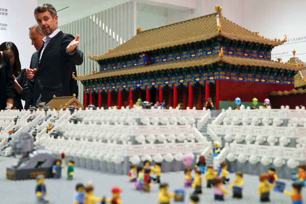 In this file photo, Danish Crown Prince Frederik, center, chats with invited guests as they look at the Forbidden City made of Lego bricks on display at the Royal Modern Household Exhibition at the Danish Cultural Center in 798 art district in Beijing. Danish toy maker Lego said Thursday that it has won major legal victory in China, where a court ruled in its favor in a copyright case against companies making knockoffs of its famous colored bricks. — AP