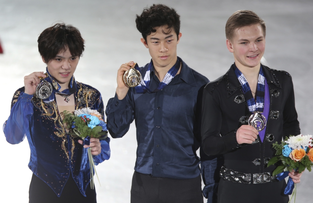 Men's free skating gold medalist Nathan Chen of the United States, center, silver winner Shoma Uno of Japan, left, and bronze winner Mikhail Kolyada of Russia pose for a photo with their medals during the awarding ceremony of the ISU Grand Prix of Figure Skating Final Friday. — AP