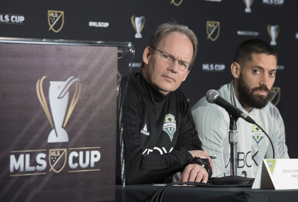 Seattle Sounder head coach Brian Schmetzer, left, and forward Clint Dempsey listen to a question during a news conference in Toronto, Thursday. The Sounders face Toronto FC in the MLS Cup soccer final on Saturday. — AP