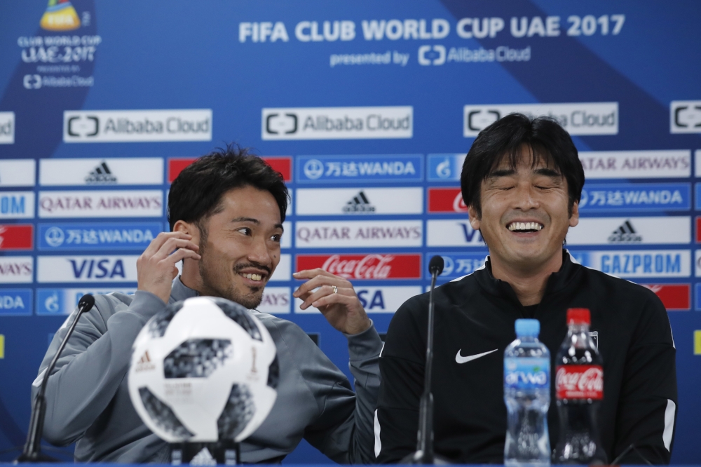 Japan's Urawa Reds head coach Takafumi Hori, right, laughs with his player Yuki Abe before their press conference at Zayed sport city in Abu Dhabi, United Arab Emirates, Friday. Urawa Reds will play Al Jazira Club in a second round of the FIFA Club World Cup soccer tournament. — AP