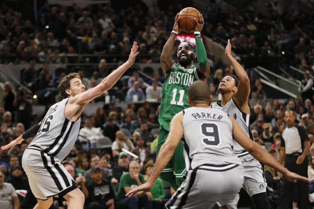 Boston Celtics point guard Kyrie Irving (11) shoots the ball as San Antonio Spurs center Pau Gasol (16) and Tony Parker (9) and Bryn Forbes defend during the second half at AT&T Center. — Reuters