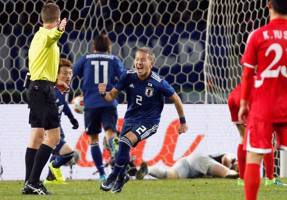 Japan's Yosuke Ideguchi (C) celebrates after scoring a goal against North Korea in the East Asian Football Championship at the Ajinomoto Stadium, Tokyo,on Saturday. — Reuters