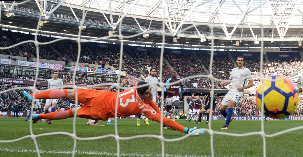 West Ham United's Marko Arnautovic scores their first goal past Chelsea's Thibaut Courtois  during the Premier Soccer League action at the London Stadium on Saturday. – Reuters