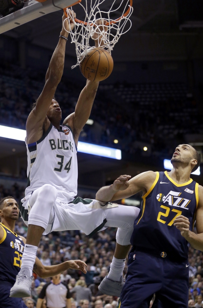 Milwaukee Bucks' Giannis Antetokounmpo dunks over Utah Jazz's Rudy Gobert during the first half of an NBA basketball game Saturday in Milwaukee. — AP