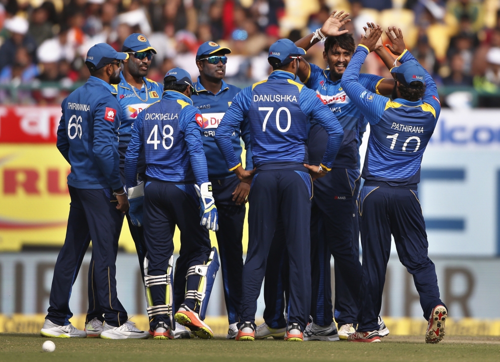 Sri Lanka's Suranga Lakmal, second right, celebrates with teammates the dismissal of India's Manish Pandey during their first one-day international cricket match in Dharmsala, India, Sunday, Dec. 10, 2017. (AP Photo/Altaf Qadri)