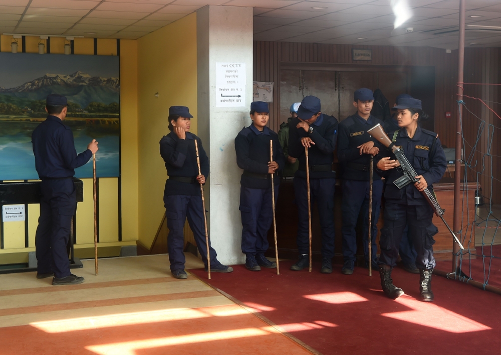 Nepali police stand guard at a vote counting area in Kathmandu on Friday. — AFP