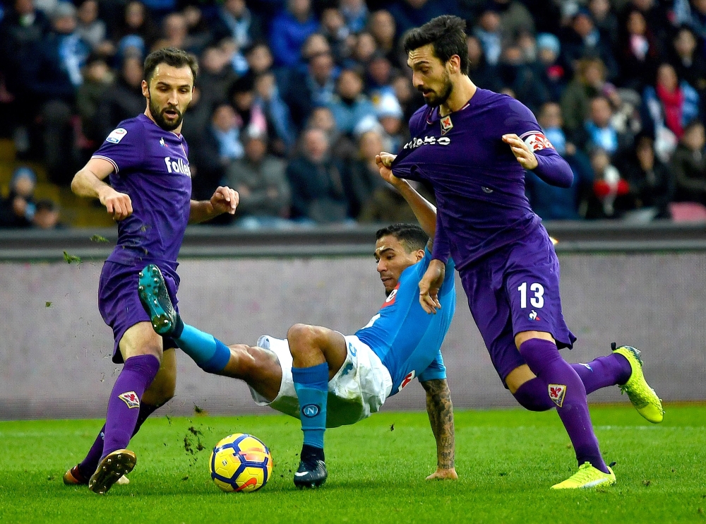 Napoli's Brazilian midfielder Marques Loureiro Allan (C) fights for the ball with Fiorentina's Italian defender Davide Astori (R) and Fiorentina's Croatian midfielder Milan Badelj (L) during the Italian Serie A football match  at San Paolo stadium in Naples on Sunday.  — AFP