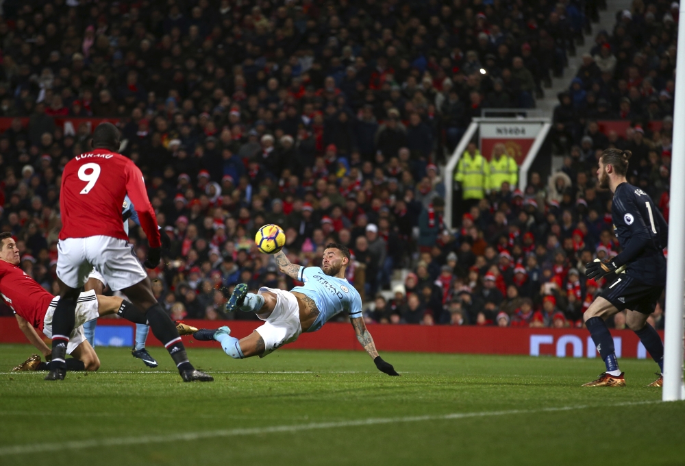 Manchester City's Nicolas Otamendi, center, scores his side's second goal during the English Premier League soccer match between Manchester United and Manchester City at Old Trafford Stadium in Manchester, England, Sunday. — AP