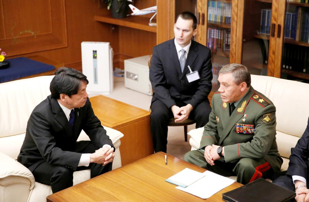 General Valery Gerasimov, Chief of the General Staff of the Armed Forces of Russia, talks to Japan’s Defense Minister Itsunori Onodera, left, during their meeting at the Defense Ministry in Tokyo, Japan, on Monday. — Reuters