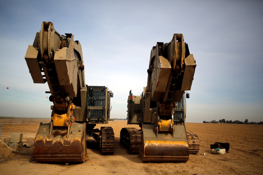 Diggers are seen near the area where the Israeli forces said a 