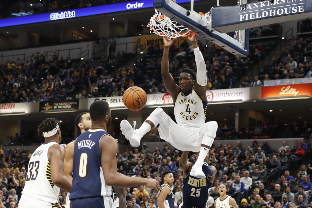 Indiana Pacers guard Victor Oladipo (4) dunks against the Denver Nuggets during the 3rd quarter at Bankers Life Fieldhouse. — Reuters
