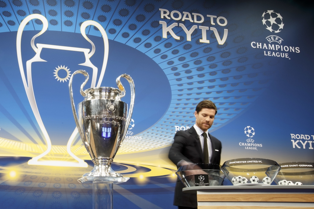 Former Spanish soccer player Xabi Alonso draws club names during the drawing of the games for the Champions League  Round of 16, at the UEFA headquarters, in Nyon, Switzerland, Monday. — AP