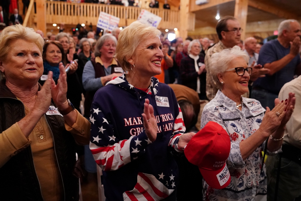 Supporters cheer at a Republican Senate candidate Roy Moore campaign rally in Midland City, Alabama, on Monday. — Reuters