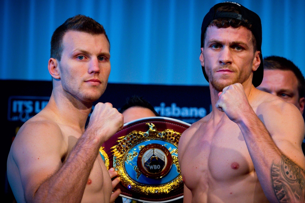 Australian Jeff Horn (L) faces off with British opponent Gary Corcoran (R) during the pre-fight weigh-in at the Brisbane Convention Centre in Brisbane on Tuesday, the eve of their World Boxing Organization welterweight title bout. English challenger Gary Corcoran has claimed Australian WBO welterweight champion Jeff Horn is a 