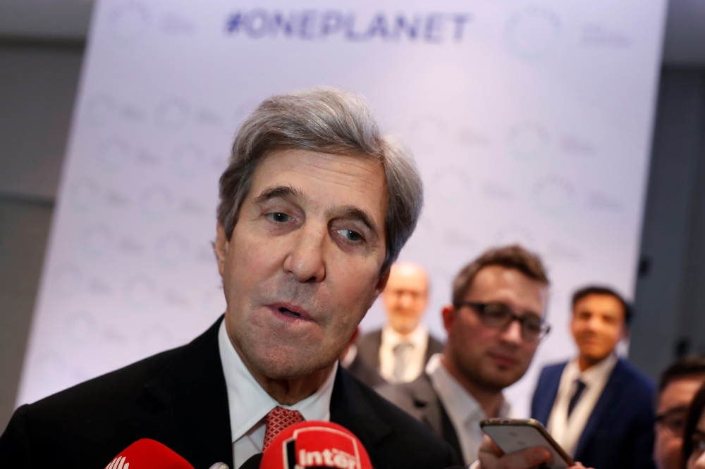 Former US Secretary of State John Kerry talks to journalists during the One Planet Summit at the Seine Musicale center in Boulogne-Billancourt, near Paris, France, on Tuesday. — Reuters