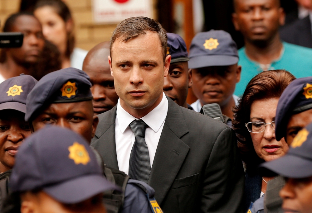 South African Olympic and Paralympic sprinter Oscar Pistorius leaves the North Gauteng High Court in Pretoria, South Africa, in this Oct. 15, 2014 file photo. — Reuters