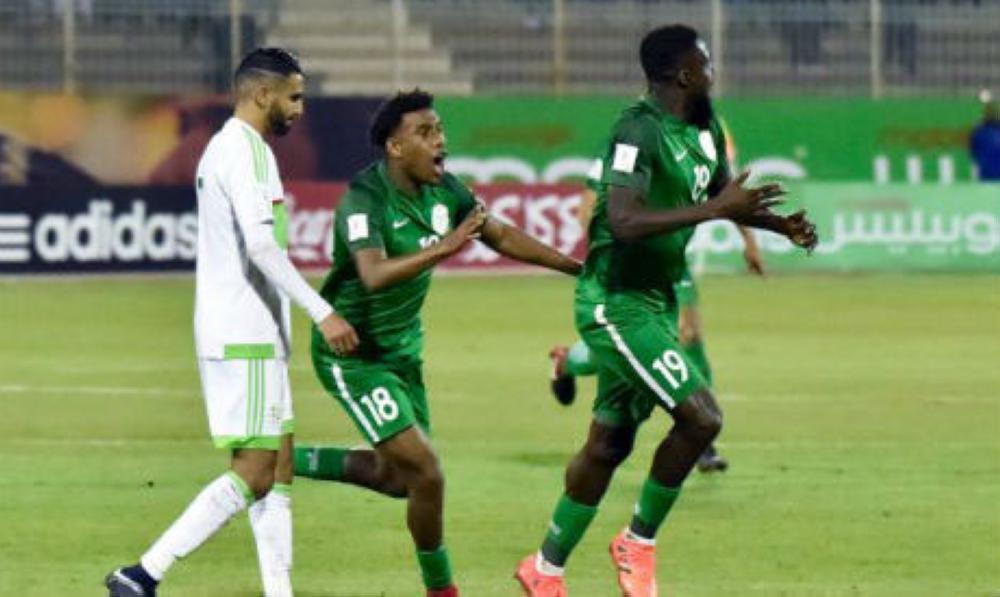 File photo shows Nigeria's John Ogu (R) celebrating with Nigeria's Alexander Iwobi (C) after scoring a goal during the 2018 FIFA World Cup Group B qualifying football match against Algeria at the Chahid Hamlaou Stadium in Constantine on Nov. 10. — AFP
