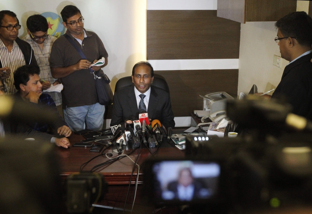 Bangladeshi Counter Terrorism and Transnational Crime unit (CTTC) Chief Monirul Islam, center, speaks to the media in Dhaka on Wednesday. — AFP