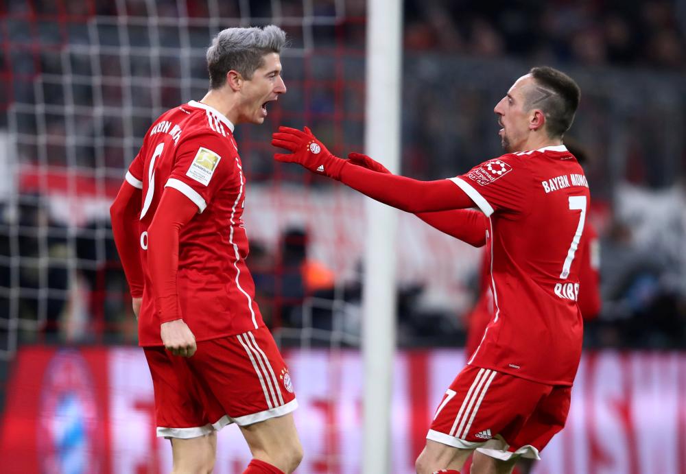 Bayern Munich’s Robert Lewandowski (L) celebrates scoring their first goal with Franck Ribery against FC Cologne at Allianz Arena, Munich, Wednesday. — Reuters