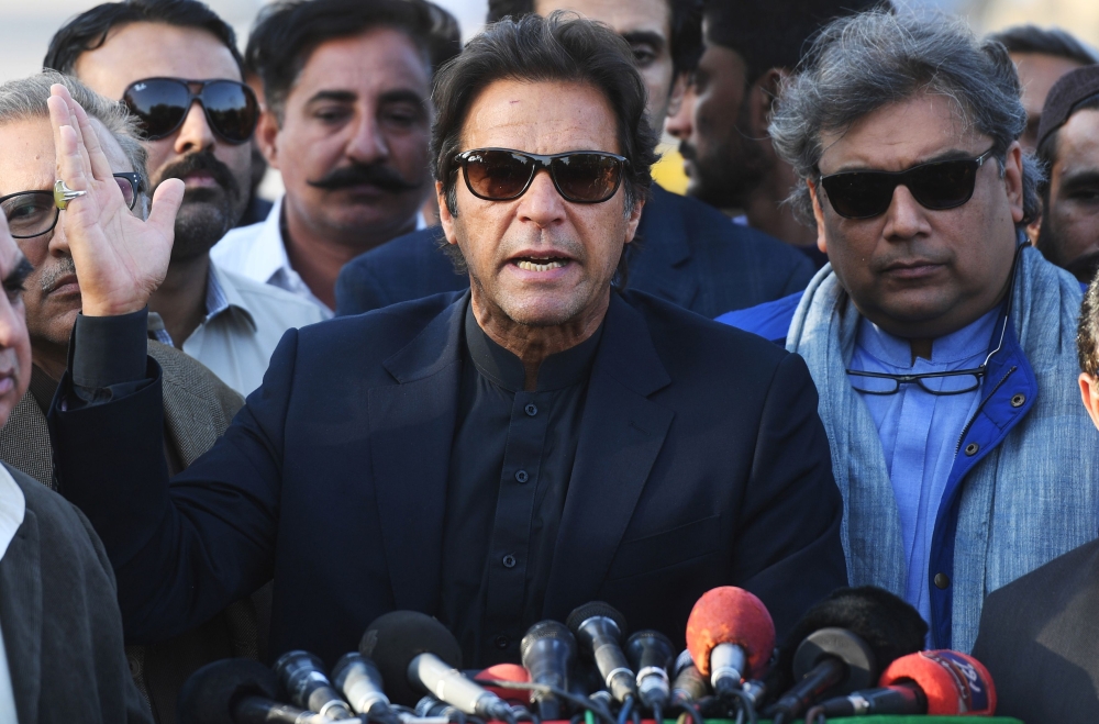 Pakistani cricketer-turned-opposition leader Imran Khan (C) gestures as he addresses the media in Karachi on Friday. Pakistan's Supreme Court dismissed a graft case against Imran Khan Friday, ensuring he will contest a general election due next year, just months after the same body ousted ex-prime minister Nawaz Sharif. Khan had faced being disqualified from holding political office over charges including unreported assets. — AFP