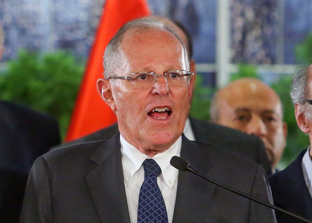A handout picture distributed by the Peruvian Presidency shows President Pedro Pablo Kuczynski appearing in Lima on a televised message to the Nation on Thursday, surrounded by his Ministers of State and and lawmakers to announce he would not resign his position, and ruled out having received illegal payments from the Brazilian construction company Odebrecht, an accusation that the political opposition is using to demand he steps down or face impeachment. — AFP