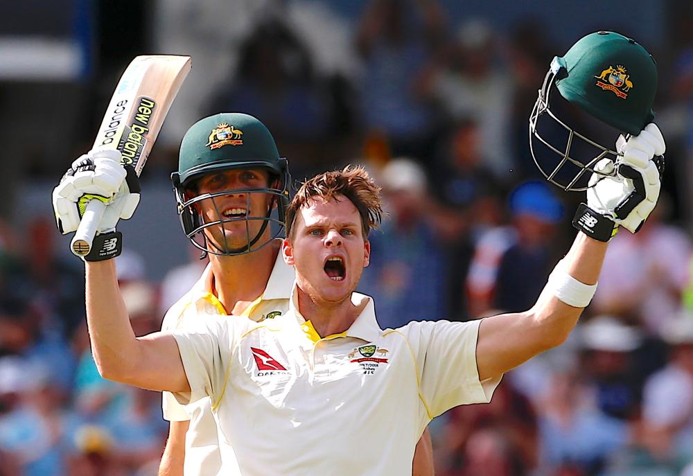 Australia’s captain Steve Smith celebrates with teammate Mitchell Marsh after reaching his double century during the third day of the third Ashes cricket Test match against England at WACA Ground, Perth, Saturday. — Reuters