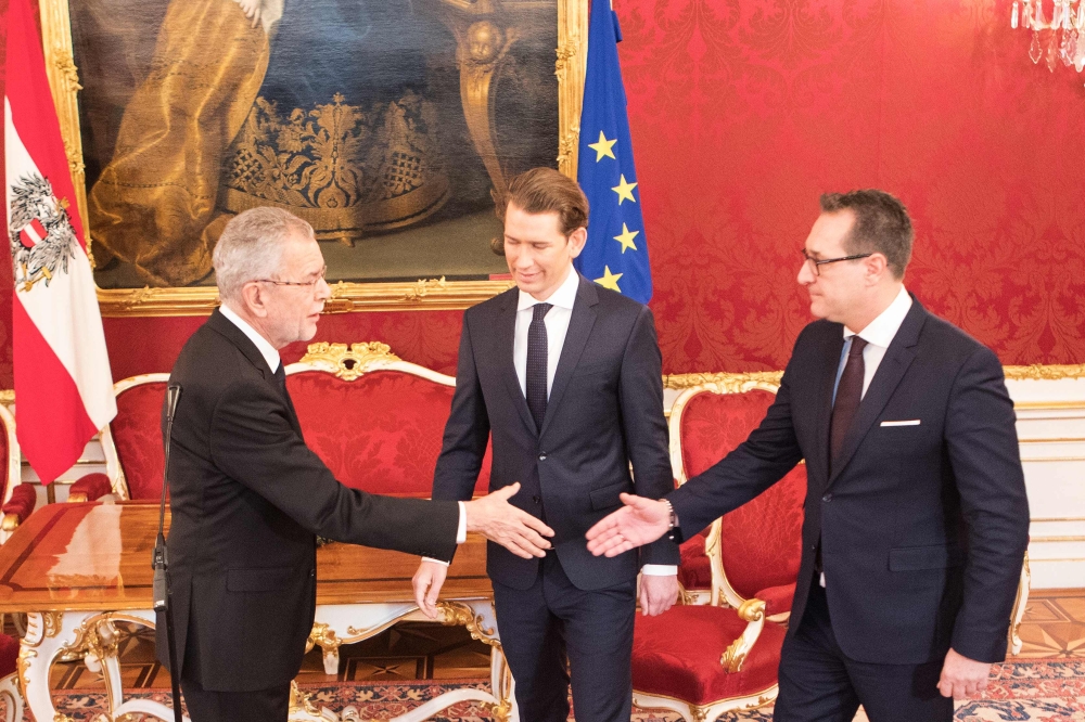 Austria’s President Alexander Van der Bellen, left, shakes hands with the Chairman of the Freedom Party (FPOe), Heinz-Christian Strache (R) during a press conference together with the leader of Austria’s conservative People's Party (OeVP) Sebastian Kurz at the Hofburg in Vienna, Austria, on Saturday. — AFP