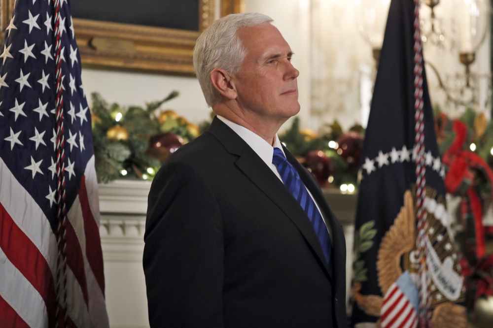 In this Dec. 6, 2017, photo, Vice President Mike Pence listens as President Donald Trump speaks in the Diplomatic Reception Room of the White House in Washington. Senior Trump administration officials outlined their view on Dec. 15, that Jerusalem's Western Wall ultimately will be declared a part of Israel, in another declaration sure to inflame passions among Palestinians and others in the Middle East. — AP