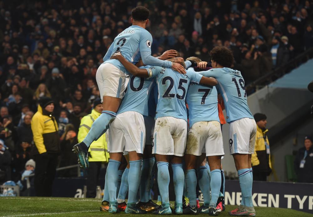 Manchester City's players celebrates after beating Tottenham Hotspur in their English Premier League football match at the Etihad Stadium in Manchester Saturday. — AFP