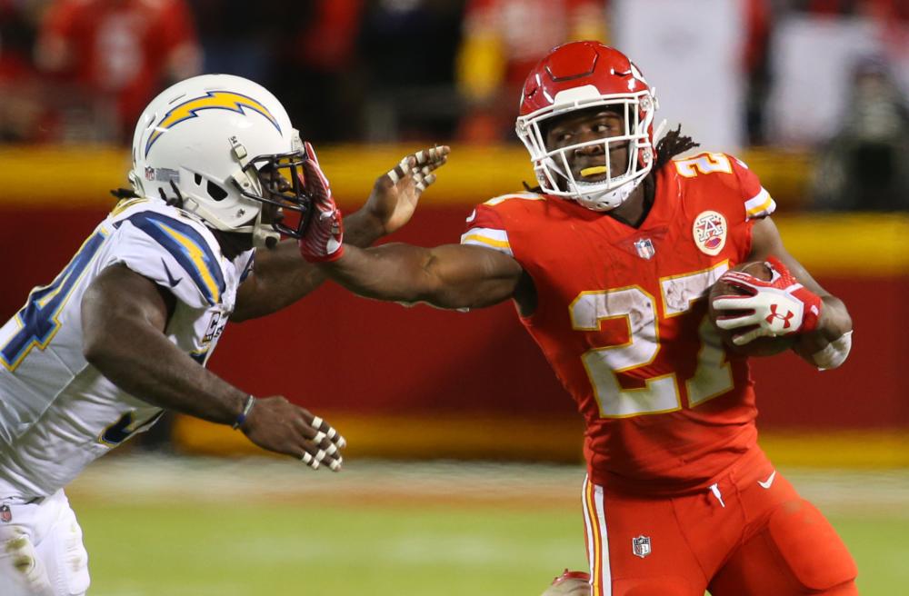 City Chiefs’ running back Kareem Hunt (R) stiff-arms Los Angeles Chargers’ linebacker Melvin Ingram during their NFL game at Arrowhead Stadium in Kansas City Saturday. — AFP