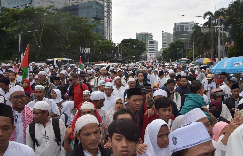 Indonesians attend a protest against US President Donald Trump’s recent decision to recognize Jerusalem as the capital city of Israel, at the US embassy in Jakarta on Sunday. — AFP