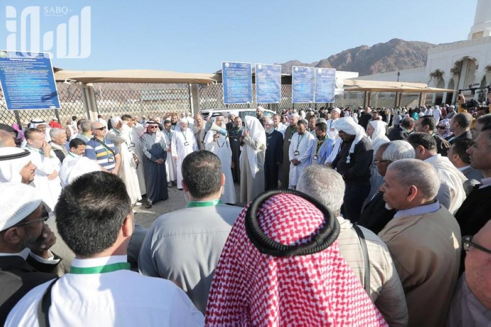 The guest pilgrims listen to a lecture outside the cemetery of the Martyrs of Uhud during a tour of the historic places of Madinah. — Courtesy photo