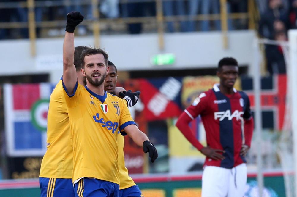 Juventus' Miralem Pjanic celebrates after scoring his side's first goal during the Italian serie A soccer match against Bologna at the Dall'Ara Stadium in Bologna Sunday. — AP