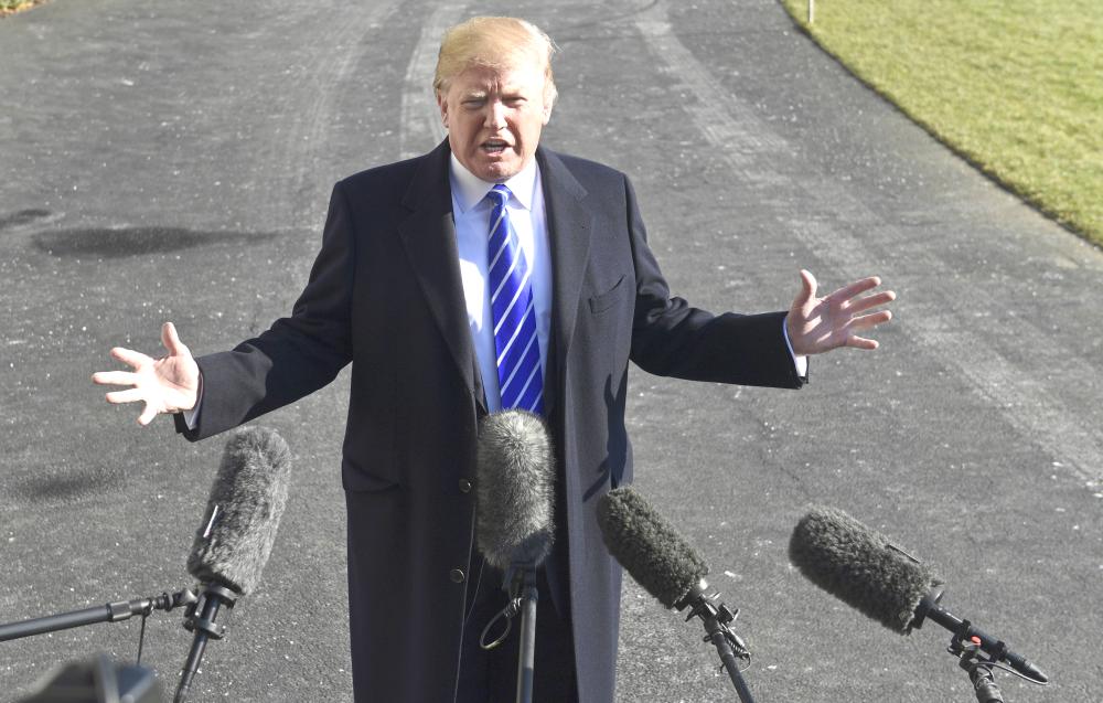 President Donald Trump talks with reporters as he departs from the South Lawn of the White House via Marine One in Washington on Saturday, to spend the weekend at Camp David in Maryland. — AP