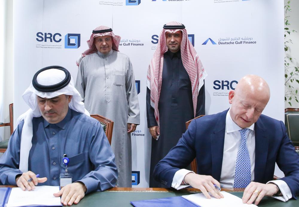 Fabrice Susini, chief executive officer, SRC, and Suliman Azzabin, chief executive officer at Deutsche Gulf Finance sign the deal in the presence of Minister of Housing Majed Bin Abdullah Al-Hugail. — Courtesy photo