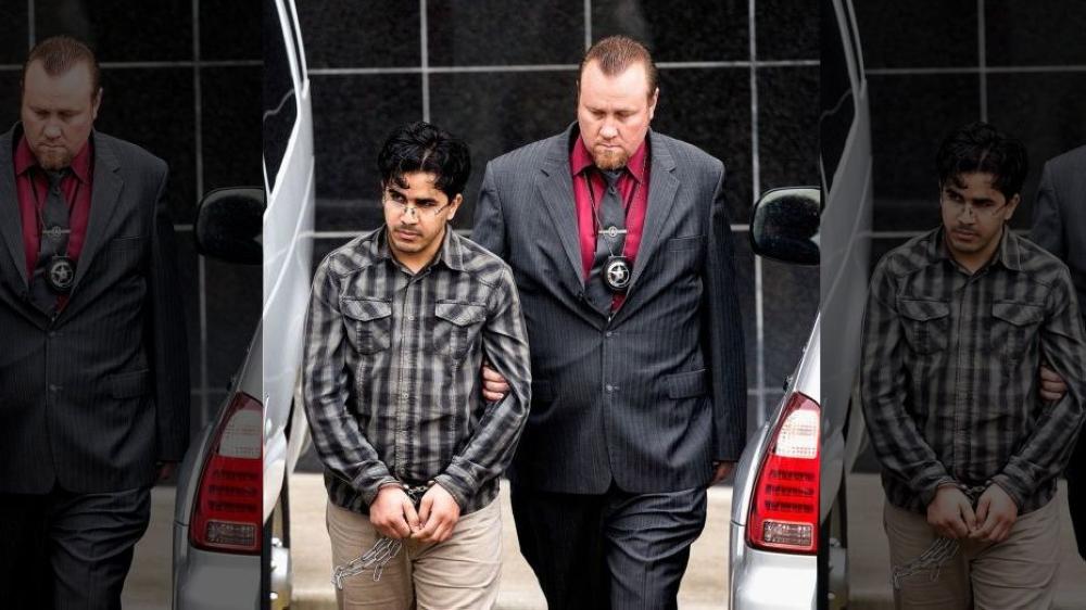 Omar Faraj Saeed Al-Hardan, left, is escorted by US Marshals from the Bob Casey Federal Courthouse in Houston. — AP file photo