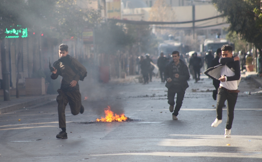 Kurdish protesters run away from tear gas during a rally against the Kurdistan Regional Government (KRG) in Sulaimaniyah, Iraq. — Reuters