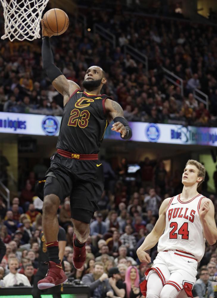Cleveland Cavaliers’ LeBron James drives to the basket past Chicago Bulls’ Lauri Markkanen during their NBA game in Cleveland Thursday. — AP