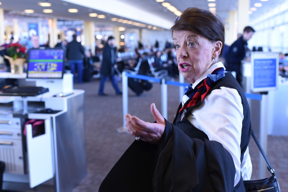 American Airlines longest serving flight attendant, Bette Nash, right, 81 years old, checks the passengers’ seats for forgotten items before disembarking from her daily return flight to Boston at Ronald Reagan Washington Airport in Arlington, Virginia, on Tuesday. — AFP