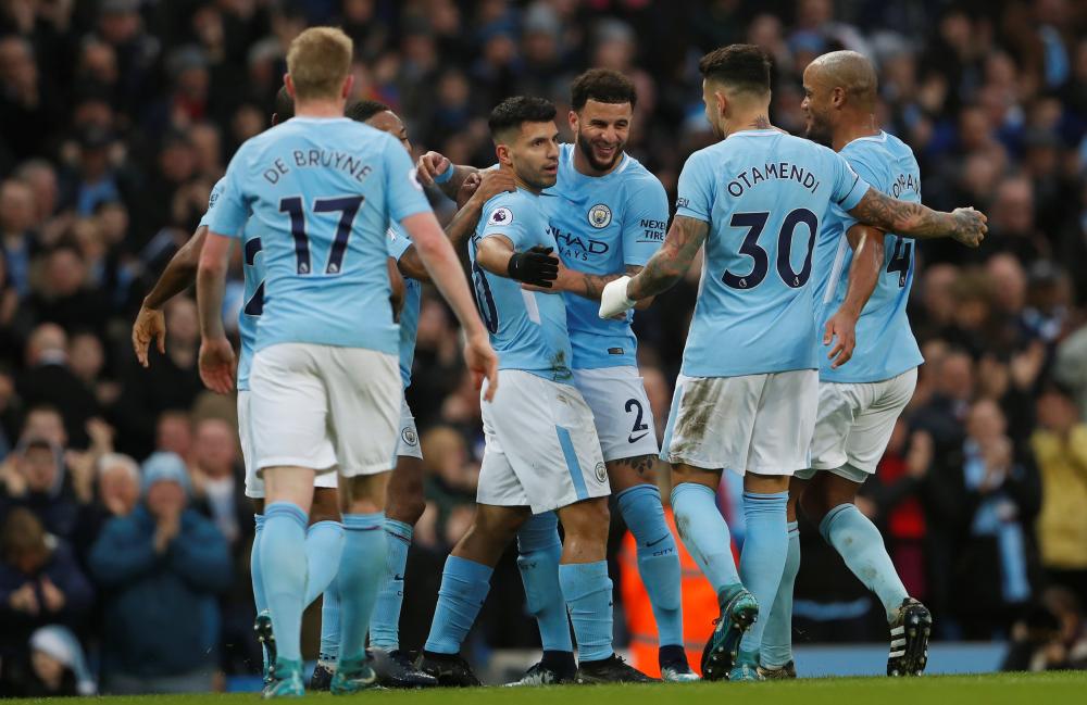 Manchester City's Sergio Aguero celebrates scoring their first goal with teammates during their English Premier League match with Bournemouth at the Etihad Stadium in Manchester Saturday. — Reuters