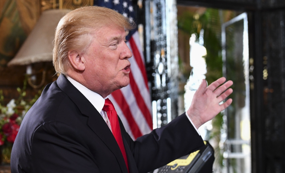 US President Donald J. Trump gestures as he participates in a video teleconference call with military members on Christmas Eve in Palm Beach, Florida, on Sunday. — AFP