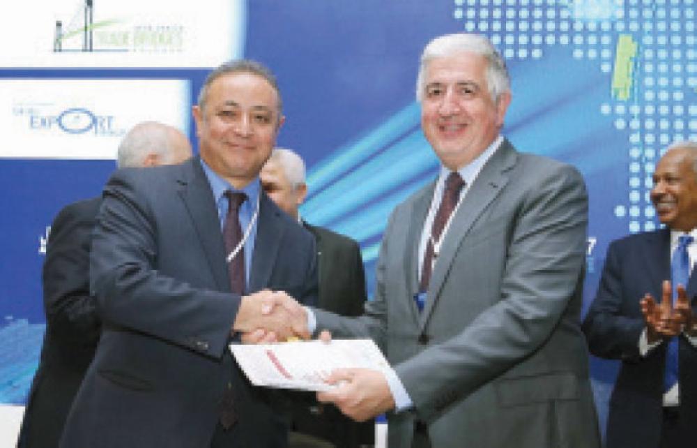 

Officials shake hands during the signing of the agreement.