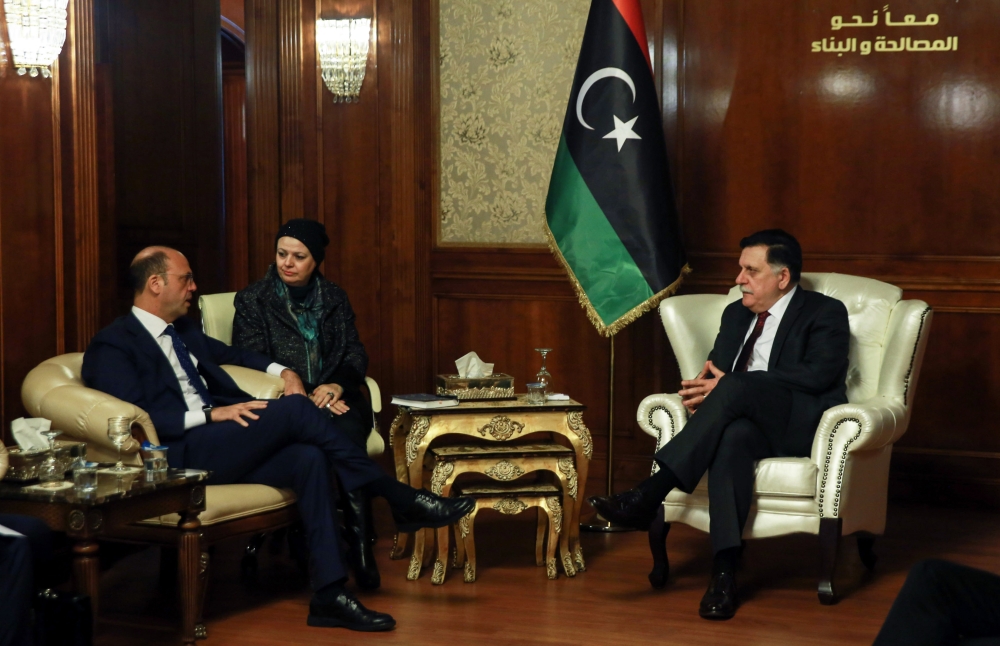 Libya's unity government Prime Minister Fayez Al-Sarraj (R) meets Italy's Foreign Minister Angelino Alfano (L) in the capital Tripoli. — AFP